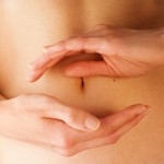 women holding her hands in circle shape in front of her stomach
